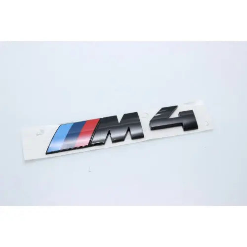 BMW M4 badge on a white background